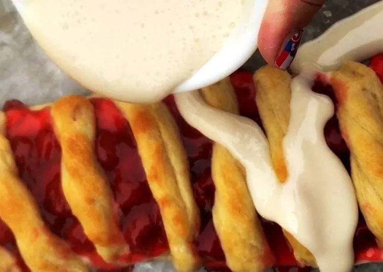 Looking for a Christmas dessert or breakfast idea? Try this easy candy cane cherry cheese danish with crescent rolls and cream cheese. SO good and festive for your holiday meal. 
