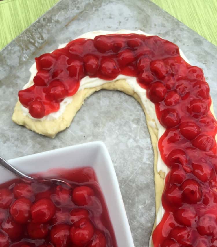 Looking for a Christmas dessert or breakfast idea? Try this easy candy cane cherry cheese danish with crescent rolls and cream cheese. SO good and festive for your holiday meal. 
