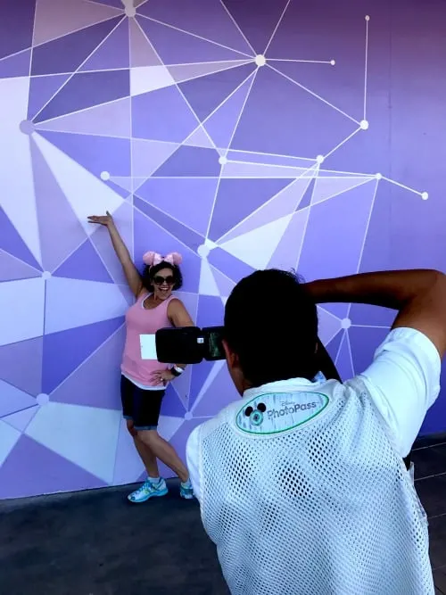 Purple Wall In Disney World PhotoPass Photographer taking the picture to remember your Disney vacation