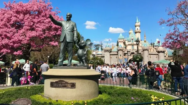 Sleeping Beauty Castle and Partners Statue in the Spring Disneyland free stuff in Disneyland