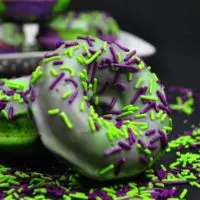 Marvel Incredible Hulk cake donuts on a plate with green and purple sprinkles