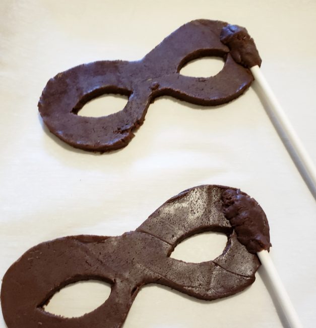 dough covering the stick in the Incredibles cookie mask
