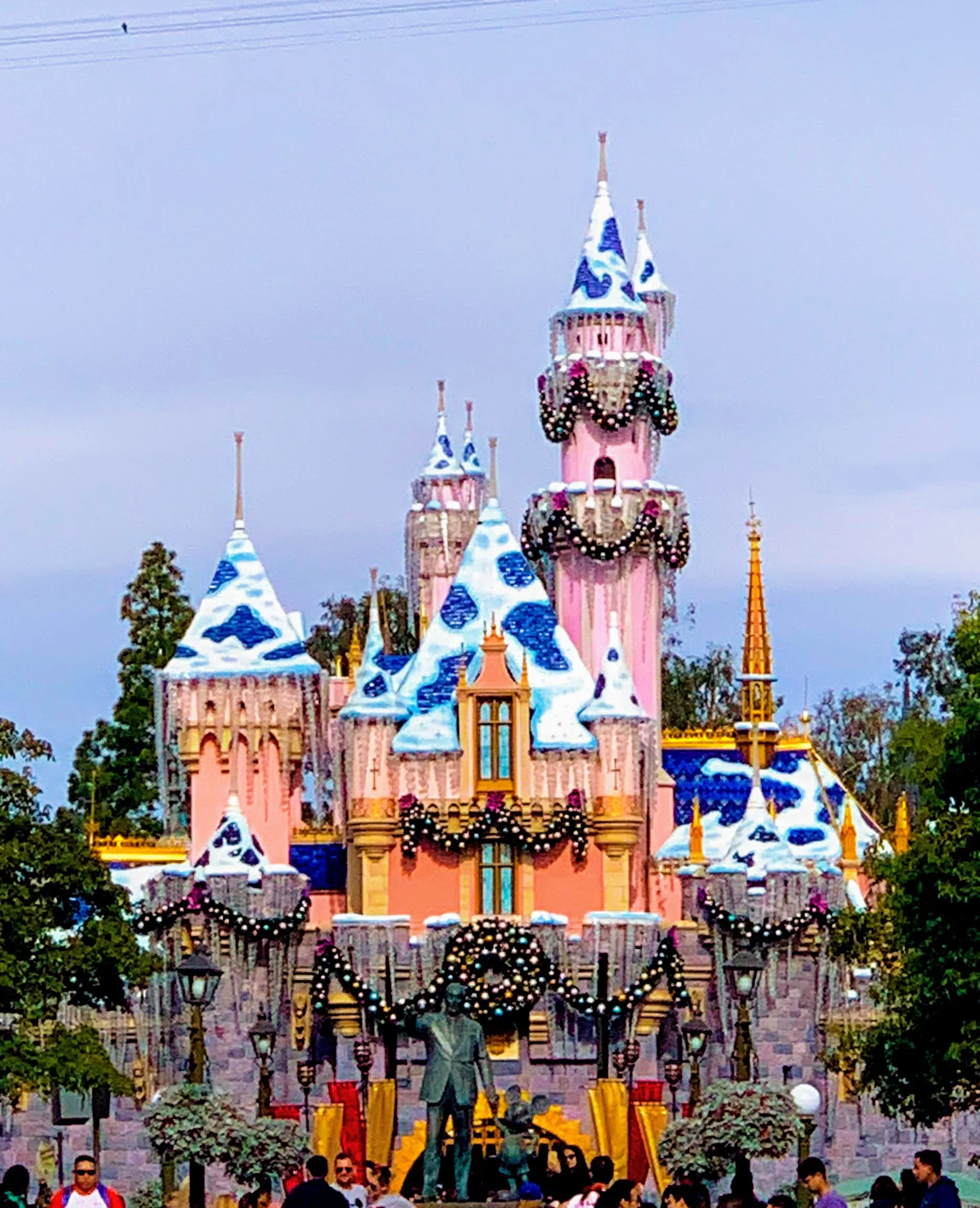 Sleeping Beauty Castle with snow and Christmas decorations. disneyland christmas tips