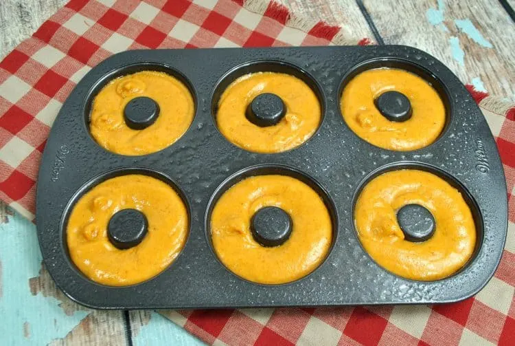 pumpkin spice donut batter poured into donut pan
