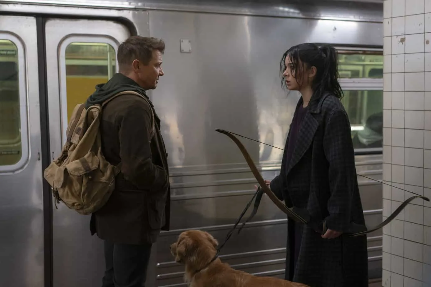 lines from Kate Bishop in Hawkeye. Clint, Kate, and dog lucky in front of subway