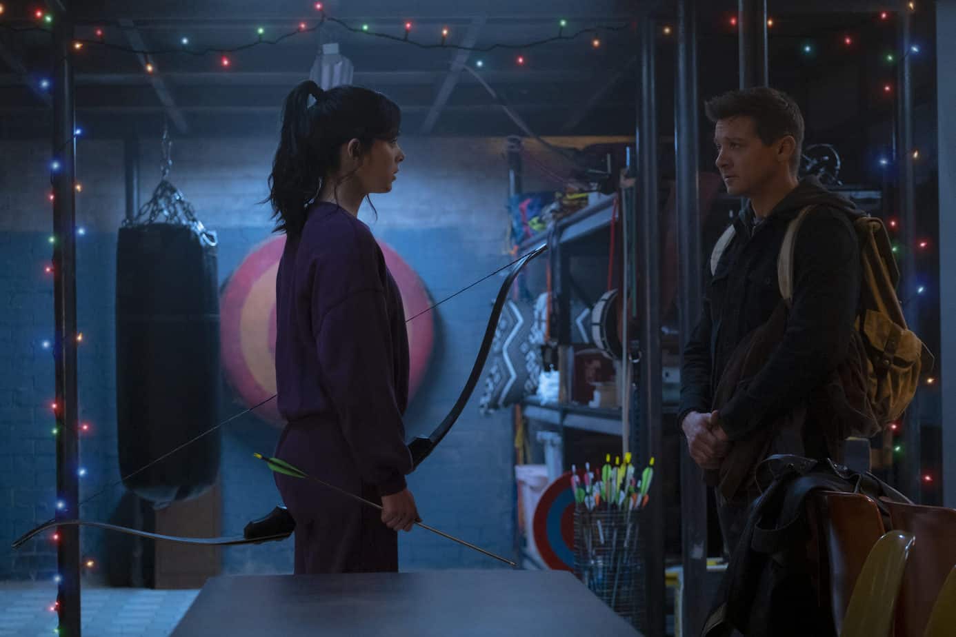 girl holding a bow and arrow and a man look at each other. Kate Bishop quotes from Hawkeye