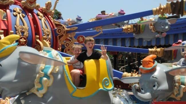 boys on Dumbo at Disney world
