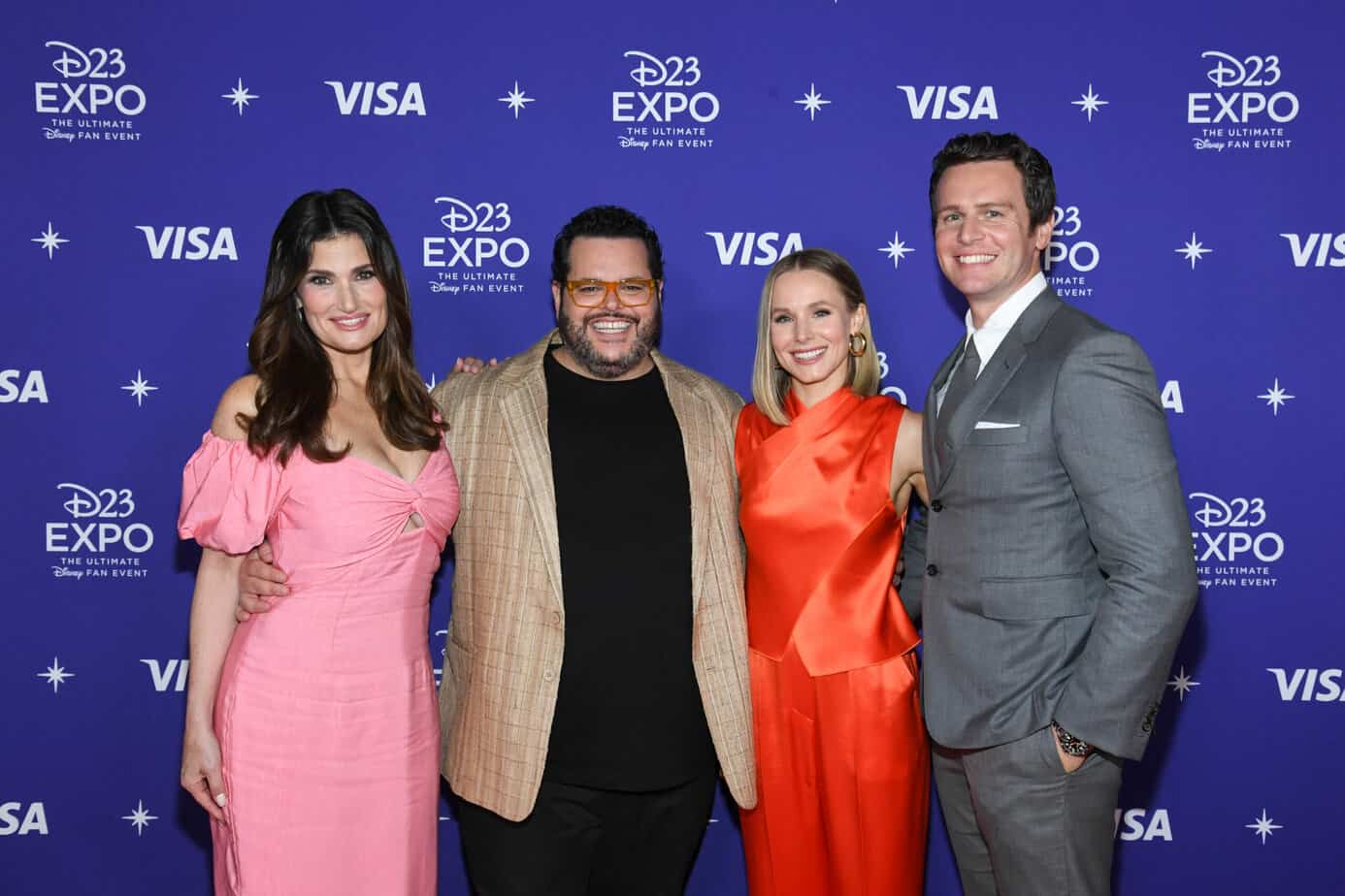 Disney Legends Idina Menzel, Josh Gad, Kristen Bell, and Jonathan Groff standing in front of a D23 Expo sign.
