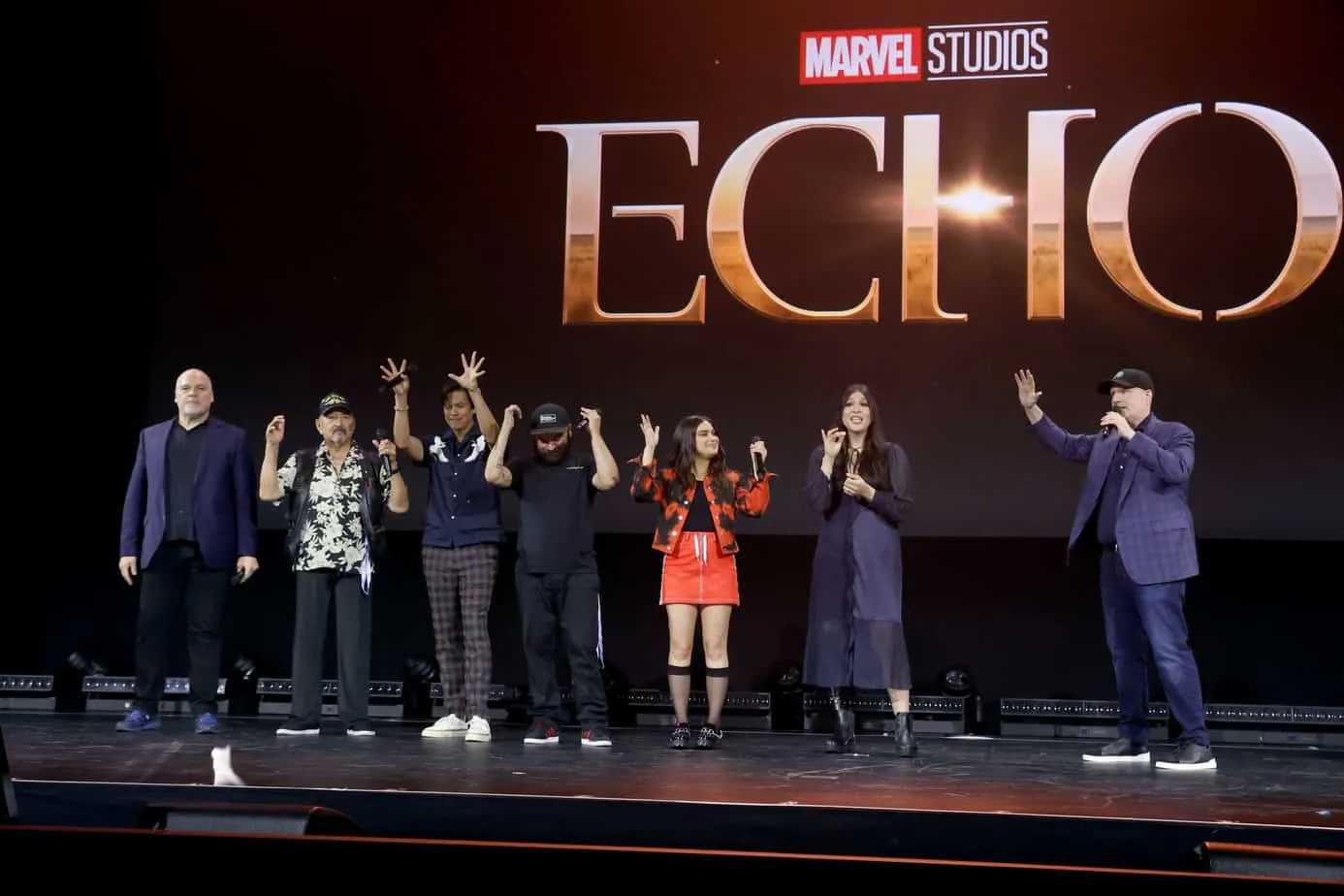 The cast of Echo on stage during the Marvel Studios panel at D23 Expo 2022 with the Echo logo behind them.