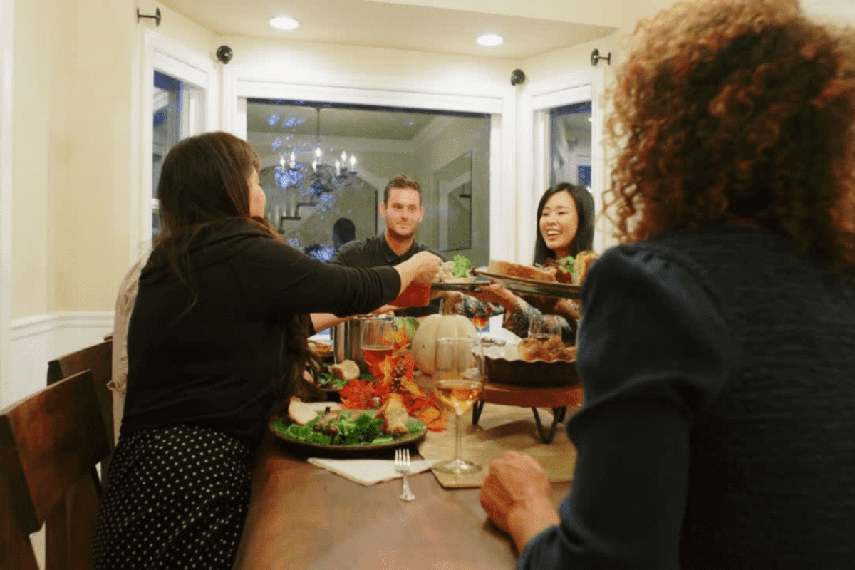 Funny thanksgiving poems. family passing food at the thanksgiving table.