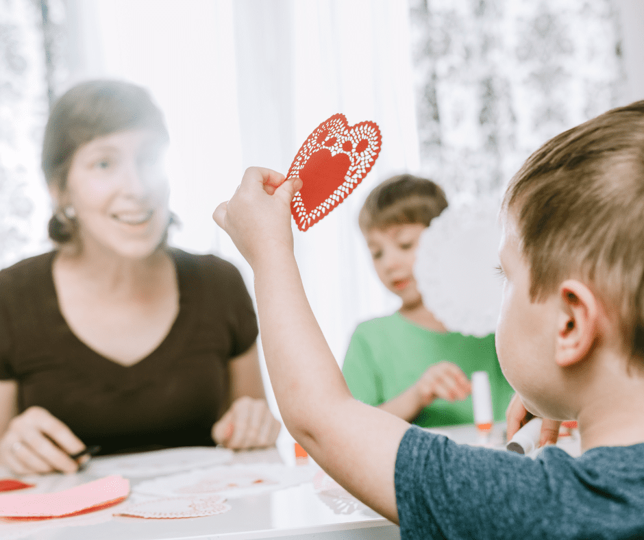 kids making valentines with an adult. Valentines Day Word Search printable PDF.